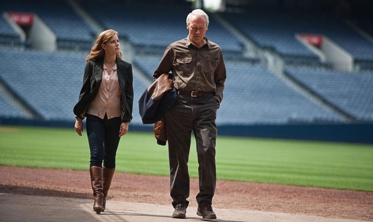 Photo of Amy Adams and Clint Eastwood walking across a baseball stadium infield