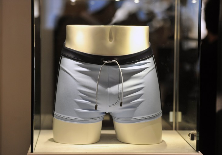 Photo of Daniel Craig's gray squared-off swim trunks in a glass display case
