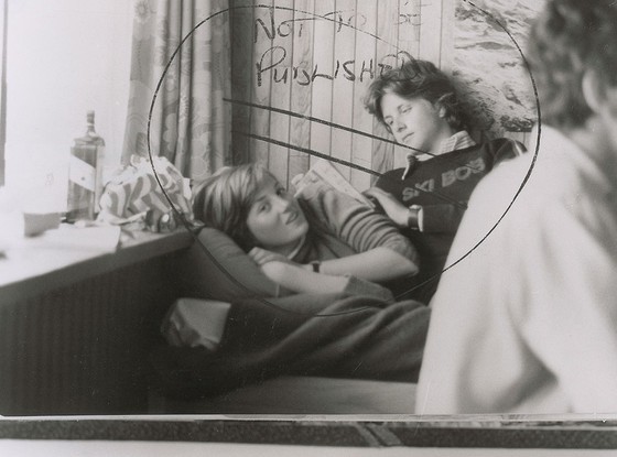 A photo of Princess Diana as a young teen, lying on a bed and chatting with a boy