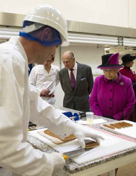 Queen Elizabeth photo as she looks at chocolates being made