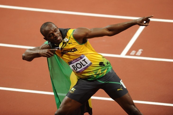 Photo of Usain Bolt in his winning pose, pointing along his body with both index fingers