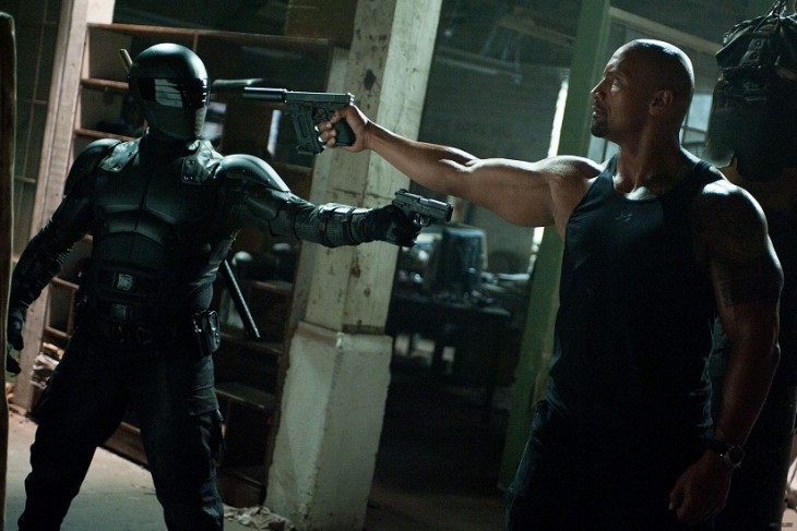 A photo of The Rock facing off with a masked dude of some kind, guns drawn on each other, in 'GI Joe'