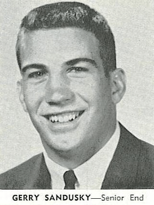 A photo of Jerry Sandusky with a crew cut, grinning, with the caption 