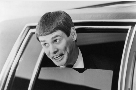 Photo of Jim Carrey with a bowl haircut in Dumb and Dumber, gawping out the window of a limo