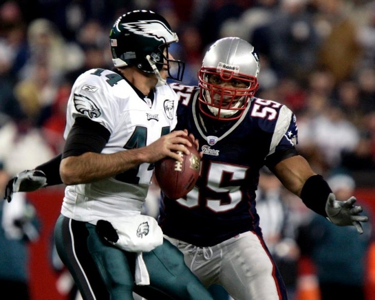 A photo of Junior Seau in a #55 uniform, rushing on at an Eagles quarterback