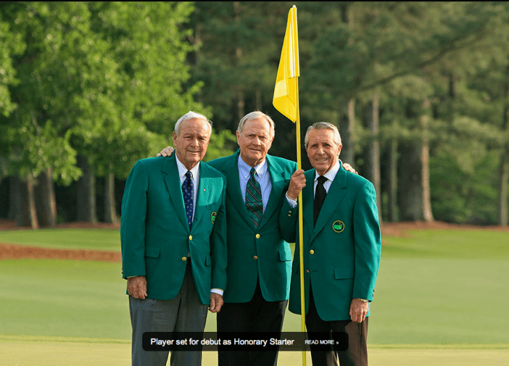 Photo of three men standing on a green with a golf flag, all wearing green jackets (except the flag)