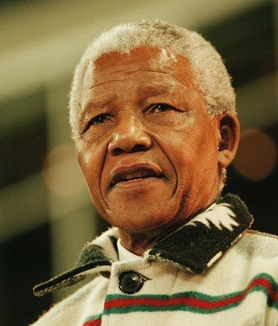 Photo of Nelson Mandela with gray hair and a wool button-up sweater