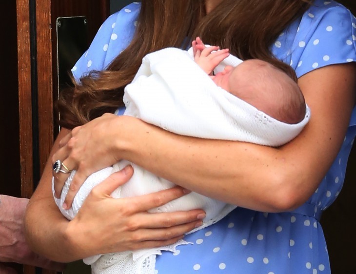 Royal baby photo of the Duke of Cambridge held in the arms of his mother, Kate Middleton