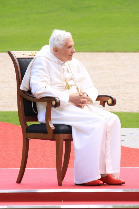 Pope Benedict XVI photo in red loafers, sitting on a chair outside