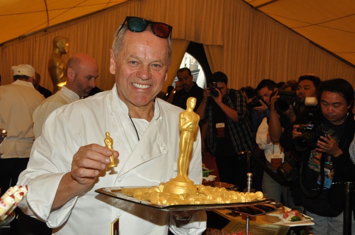 Photo of Wolfgang Puck holding up food in the shape of an Oscar