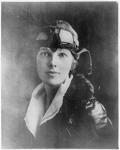 A photo of a very handsome Amelia Earhart in a leather pilot's hat and goggles
