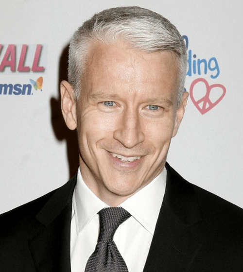 Photo of Anderson Cooper in a black suit and gray tie and his signature gray hair