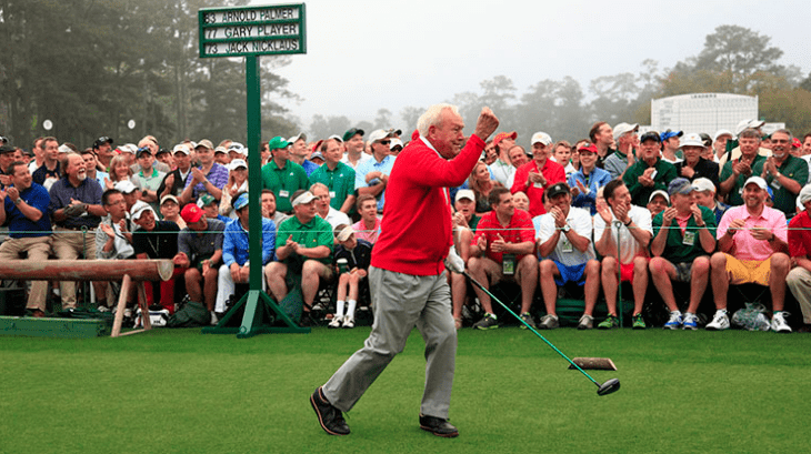 Arnold Palmer pumps his fist with satisfaction as his tee shot flies down the fairway