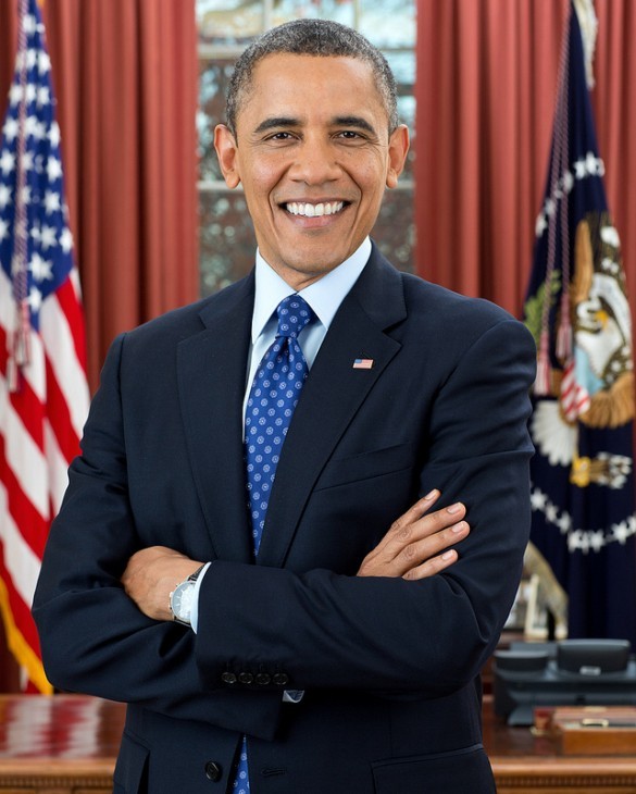 Official portrait of Barack Obama, arms crossed and grinning, in the Oval Office