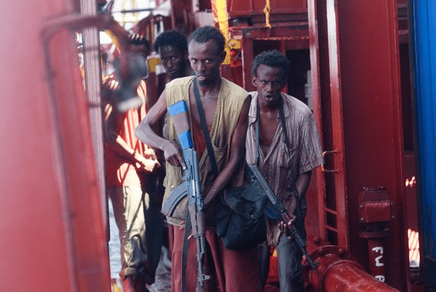 Photo of scary pirates stalking the deck of a tanker with guns