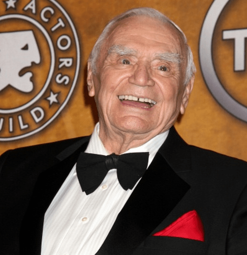 Photo of Ernest Borgnine smiling in a tuxedo with red handkerchief