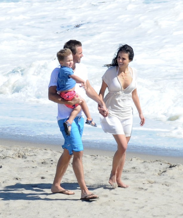 Photo of Caleb Walker and Jordanna Brewster (and movie son) walking on the beach