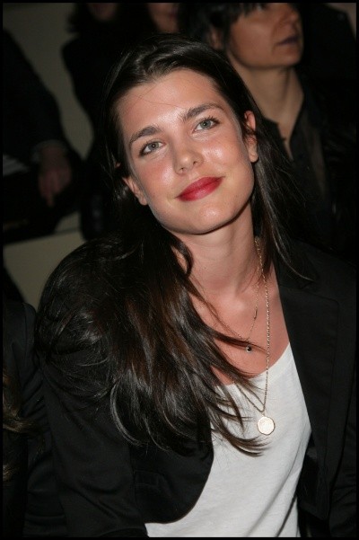 Charlotte Casiraghi photos, in a white blouse and black blazer, head cocked and smiling