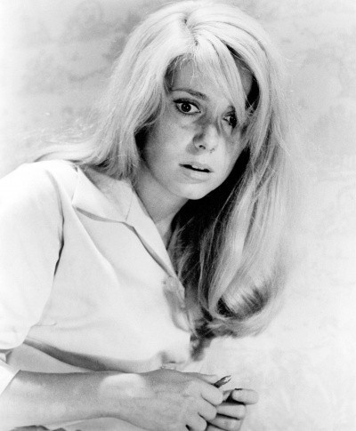 Photo of Catherine Deneuve in black and white, looking young and frightened