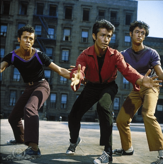 Photo of George Chakiris dancing on a playground in West Side Story