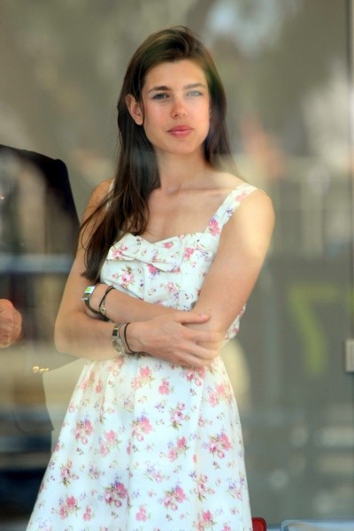 Charlotte Casiraghi photos, with her standing in white summer dress with red flowers
