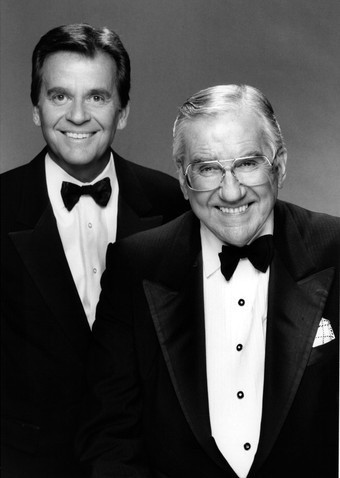 Photo of Dick Clark and Ed McMahon, in tuxedos, posing for the camera