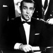 Sean Connery is a 30ish man with a wicked jaw and a cigarette in his mouth, looking perfect in a tuxedo as he sits at a poker table with a stack of gambling plaques in front of him