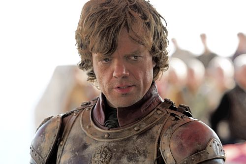 A photo of Peter Dinklage in a leather jerkin (or armor, really) looking sideways and obviously making a cutting remark