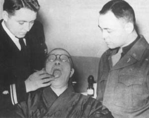 Dr. George Foster (left) examines Tojo's teeth. Photo via the Chico News & Review