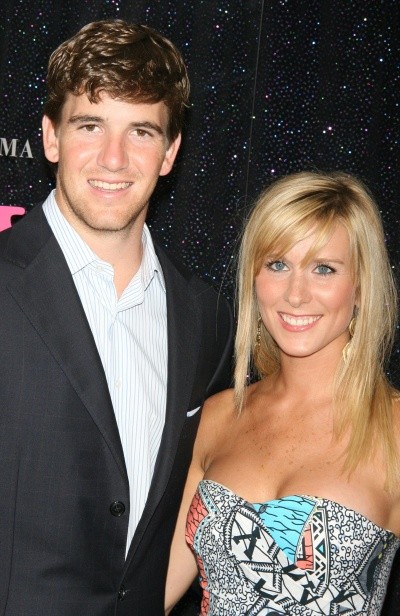 Photo of Eli Manning's wife, Abby, in a party dress with Eli paling by comparison