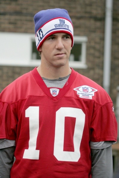 Eli Manning in red number 10 jersey and NY Giants stocking cap