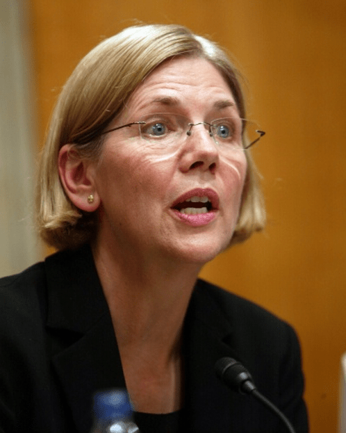 An Elizabeth Warren photo, of her at a hearing table speaking into a microphone
