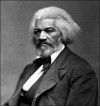 Photo of Frederick Douglass, in white hair and beard, posed formally in suit and tie