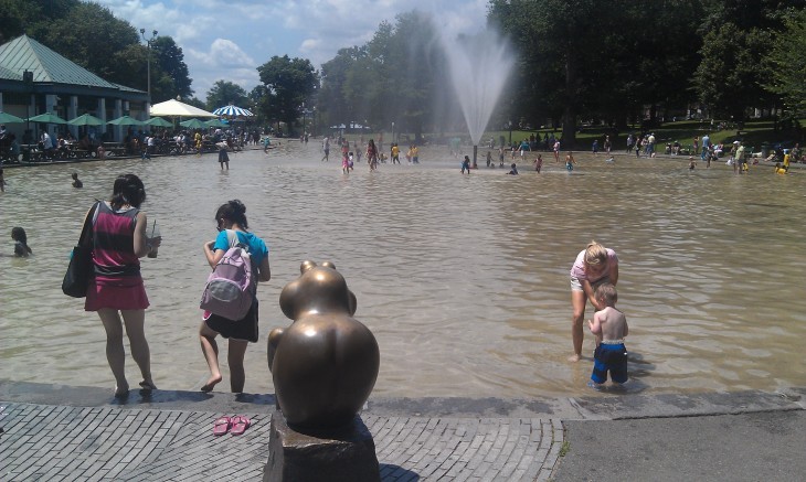 Photo of kids splashing in the Frog Pond fountain