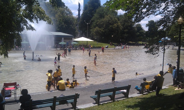Side shot of Frog Pond, with a group of yellow-shirted kids all playing together
