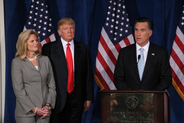 Mitt Romney speaks as Donald Trump and Mrs. Romney look on