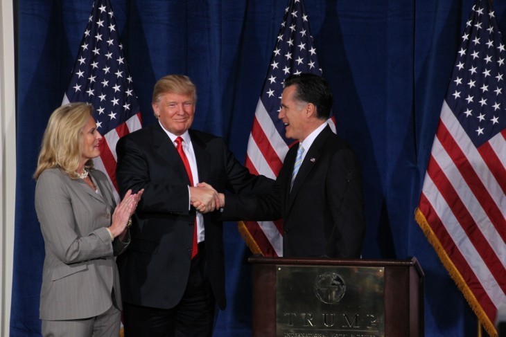 Donald Trump shakes hands with Mitt Romney on stage