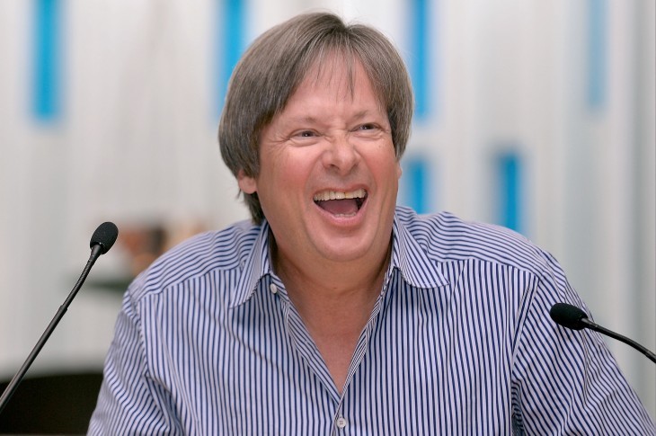 Photo of Dave Barry with a wide smile at a podium