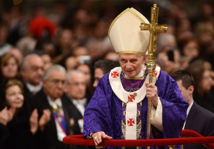 Photo of Benedict XVI in purple robe in a big cathedral, leaning on his staff