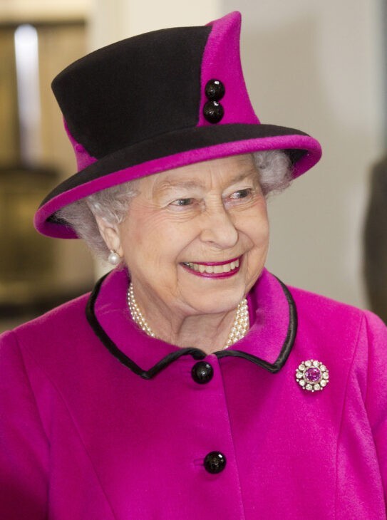 Photo of Queen Elizabeth in a bright purple outfit with crazy matching hat