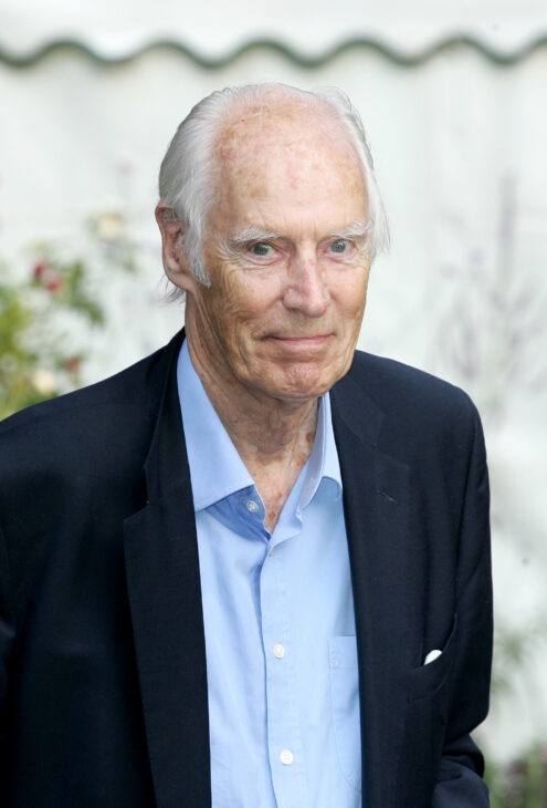 Photo of George Martin in a blue jacket and light blue shirt, gray-haired