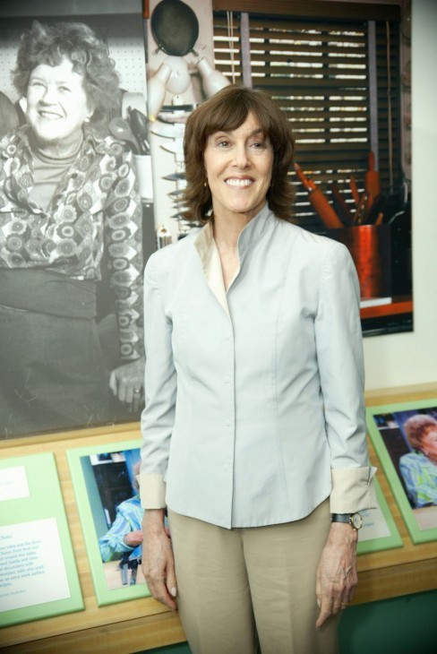 Nora Ephron photo, with Ephron standing in front of production photos for Julie and Julia
