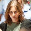 Photo of a grimly smiling Amanda Knox in courtroom