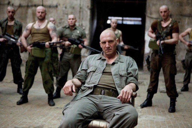 Photo of Ralph Fiennes in Coriolanus, bald and in military fatigues, slouching in a chair