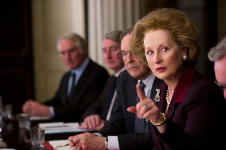 Photo of Meryl Streep as Thatcher, pointing a stern finger during a cabinet meeting