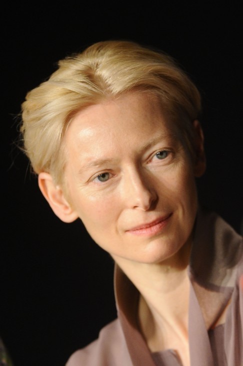 Tilda Swinton photo in ecru shirt and tilting her head sideways slightly