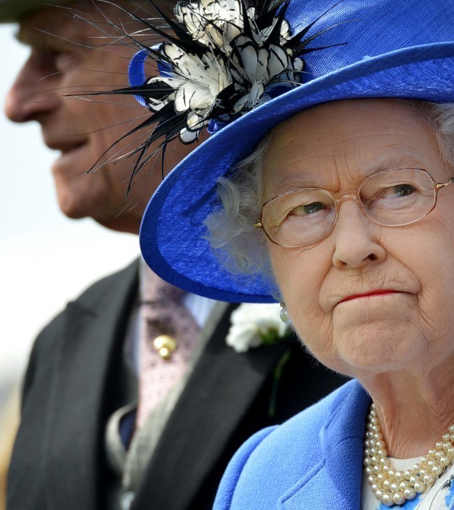 Photo of Queen Elizabeth smiling with friendly determination in a blue dress