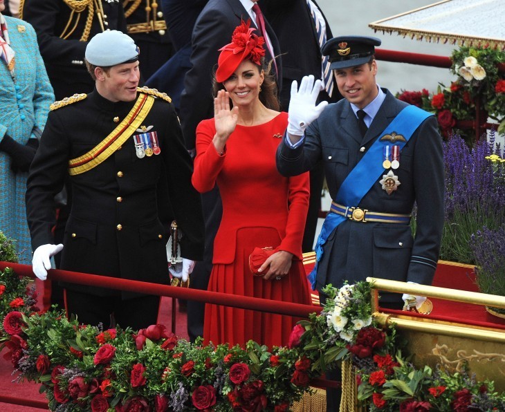 Photo of Prince Harry, Catherine, and Prince William lined up along the boat rail