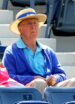 Gene Wilder, in a sweater and wide-brimmed hat that reads US OPEN, leans back in his chair. He's not smiling.