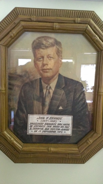 Framed photo of John F. Kennedy with a note attached, saying that he had visited the Knights Inn in 1959